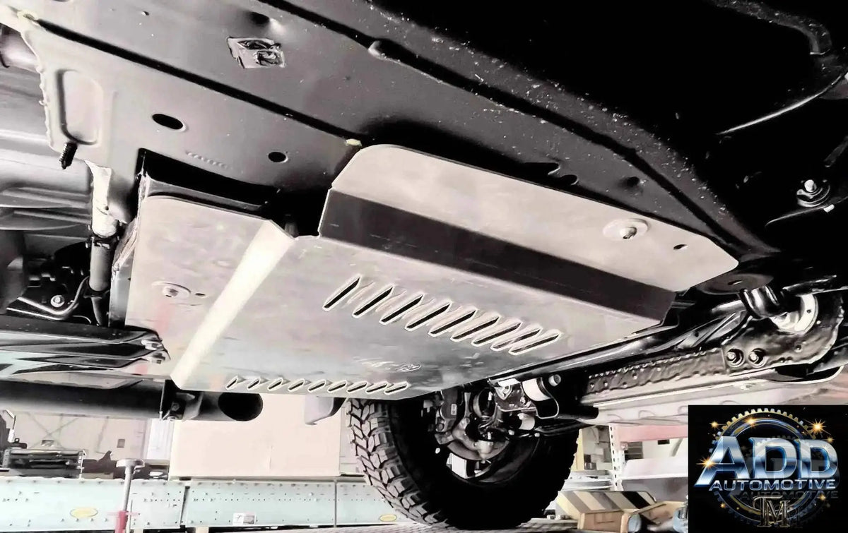 Close-up view of a catalytic converter shield installed under a vehicle to prevent theft and damage