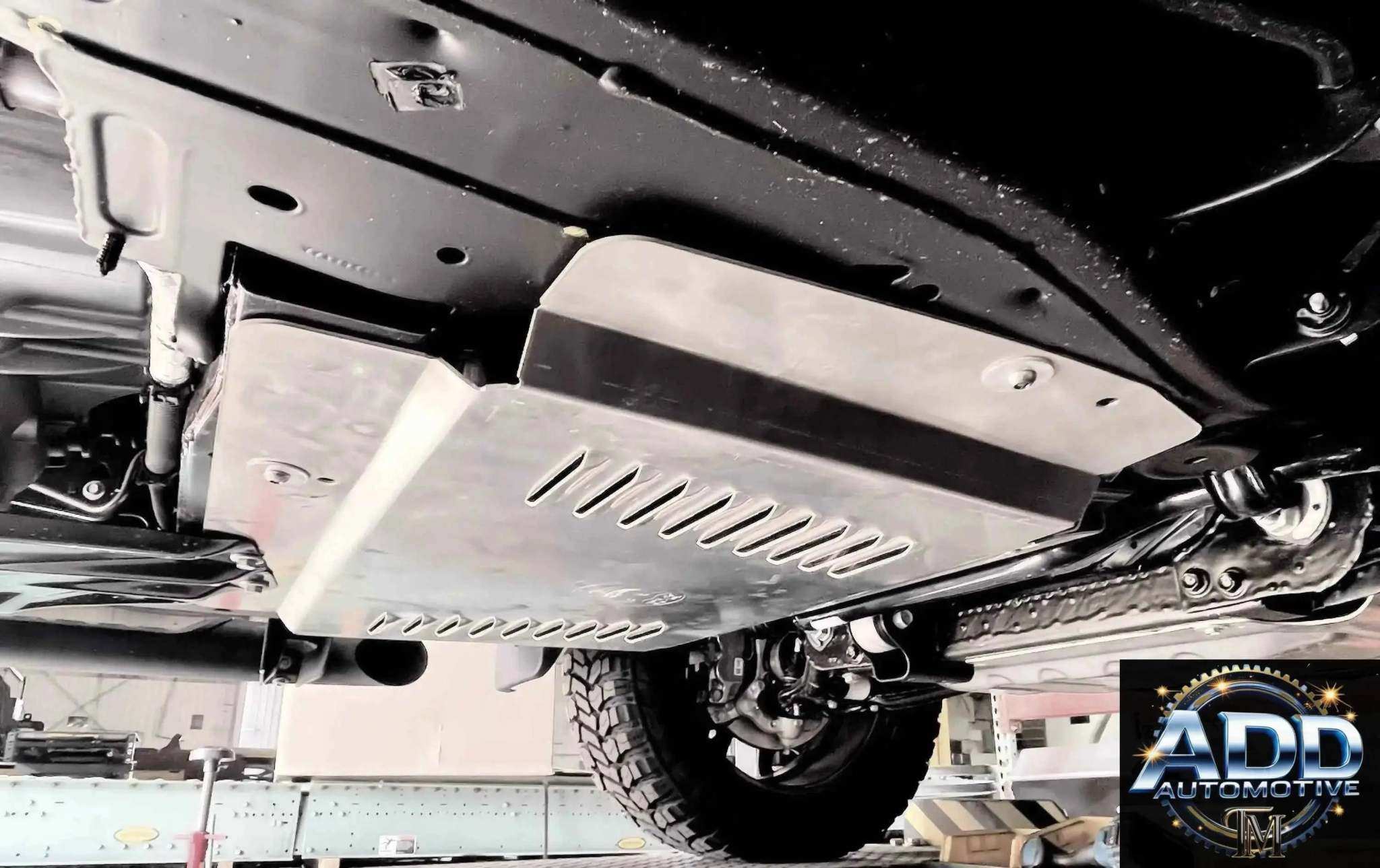 Close-up of a catalytic converter shield installed under a vehicle for theft protection