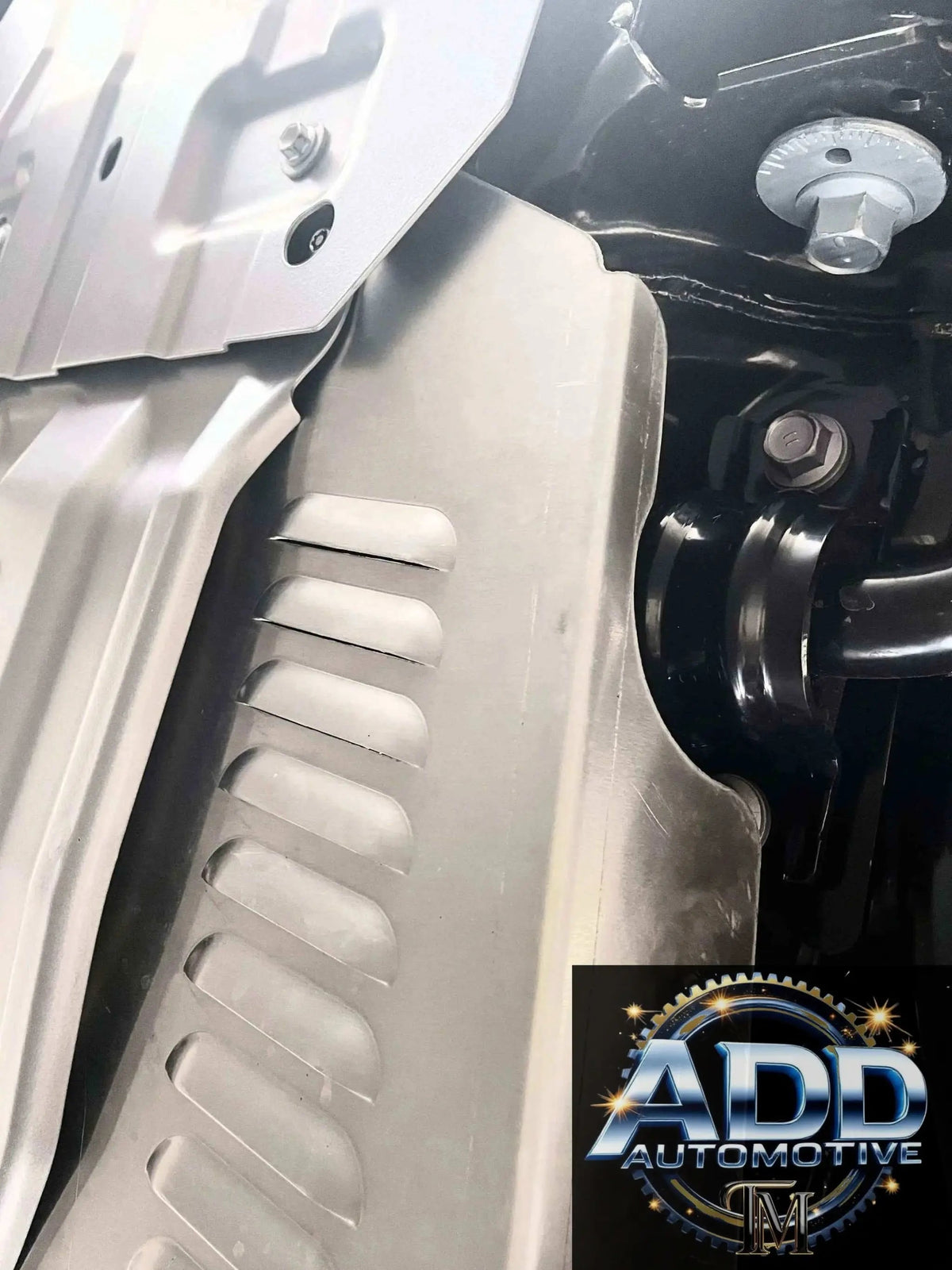 Toyota Landcruiser catalytic converter shield in silver marine-grade aluminum with ventilation louvers and bolt-on design