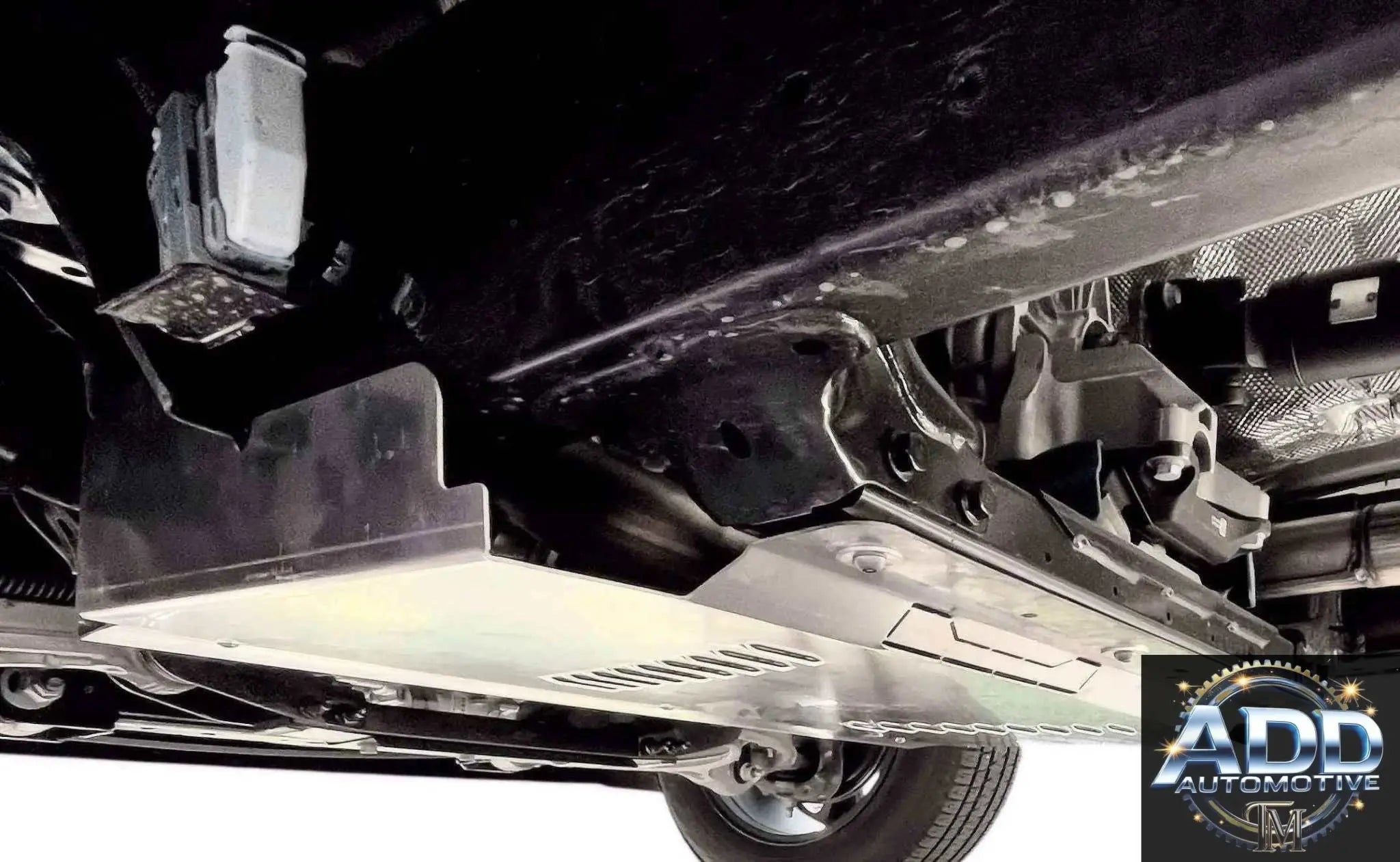 Ram 1500 Catalytic Converter Shield installed under truck with silver aluminum anti-theft cover and ventilation slots
